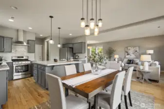 Open-concept kitchen, dining, and living area designed to keep everyone connected while enjoying meals with serene views of the surrounding greenery.( Staged picture)