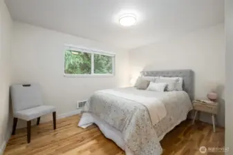The primary bedroom has direct access to the bathroom and the window looks out over the private back yard.