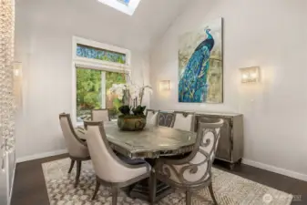The adjacent dining room overlooks the lush back garden spaces with a koi pond and waterfall.