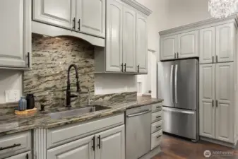So much storage behind all the gorgeous, custom cabinetry. The dining room is just off the kitchen.