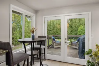 French doors past the breakfast nook lead to the deck, patio and large, private back yard.