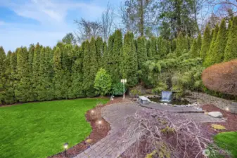 A view of the koi pond, waterfall and expansive Private yard from the deck.