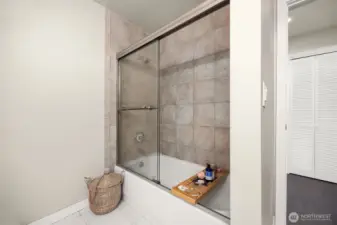 New glass enclosed, fully tiled shower and bath ready for the full spa experience.