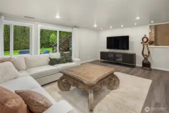 The lower level boasts an expansive 2nd living room area downstairs with sliding doors to the great outdoors! Again, all LVP flooring, and light and bright.