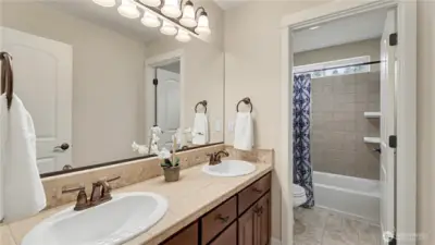 Upstairs guest bathroom, tile counters with vinyl flooring