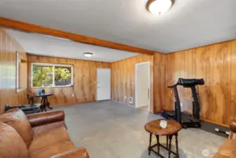 Seamlessly blend indoor and outdoor living with this versatile lower-level room, providing a separate entrance that flows effortlessly onto a back porch.