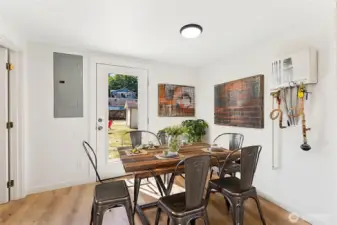 This photo is virtually staged. While there is room for a table and chairs, you'd need something a bit smaller in this space.