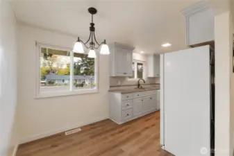 Enjoy LVP flooring, new cabinets, new lighting granite counters in this updated kitchen