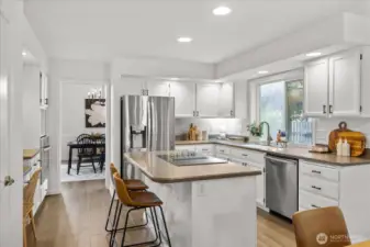 Fresh painted cabinetry, new hardware, stainless appliances, and abundant storage.