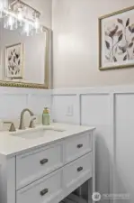 Thoughtfully updated with a newer vanity, modern lighting, and board-and-batten wall detail for added character.