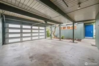 Spacious covered parking with a custom insulated modern garage door and clean architectural lines offers both functionality and style. Ample room for vehicles, storage, and easy everyday living.