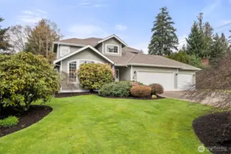 Meticulously maintained home with lush grounds.