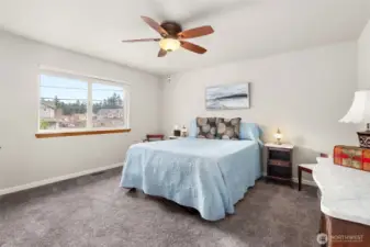 Spacious primary suite offering comfort and flexibility, with ample room to accommodate a queen-sized bed as shown.