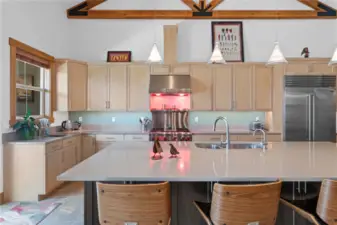 View 5 of Entertainer's kitchen with maple cabinets, quartz countertops, radiant heated tile floors, high-end appliances including a Sub-Zero refrigerator, Wolf range and oven, double Miele/Fisher-Paykel dishwashers, double ovens, 2nd prep sink and coffee bar.