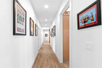 View of hallway from front door looking towards Guest Bedroom 2, the Primary Bedroom and the Laundry/utility room w/ 2nd office.