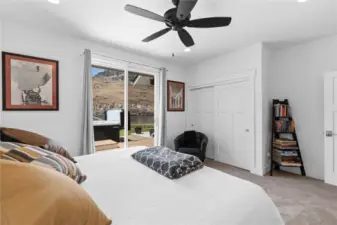 View 2 of Guest Bedroom 1 with glass sliding doors leading to the outdoor living area and swim spa overlooking the Columbia River.