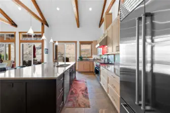 View 1 of Entertainer's kitchen with maple cabinets, quartz countertops, radiant heated tile floors, high-end appliances including a Sub-Zero refrigerator, Wolf range and oven, double Miele/Fisher-Paykel dishwashers, double ovens, 2nd prep sink and coffee bar.