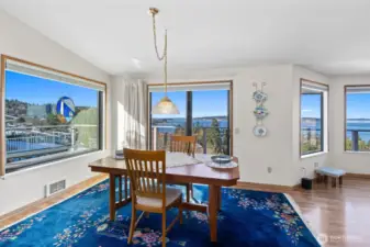 Another angle of the dining room and views with a slider to expansive AZEK plank deck & sail boat wire railing.