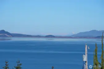 View from deck looking up towards the Canadian Cascade Mountains, Grouse Mountain and La Conner.  What a magical place to live! Sit on your deck and watch whales, boat traffic, & Victoria Clipper ferry.