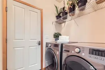 The utility room leads out to the 2 Car Garage with the EV Charger!