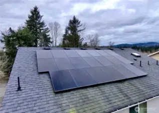 The solar panels on the back side of the house’s roof.