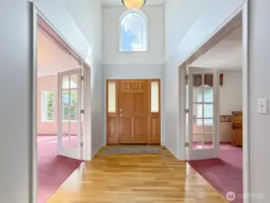 Vaulted entryway flanked by versatile bonus rooms on each side.