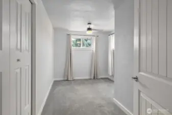 Bedroom 2 across from primary suite.