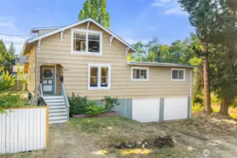 Charming 1900 Tacoma home with classic craftsman details, two-car garage, and an oversized lot surrounded by mature trees.