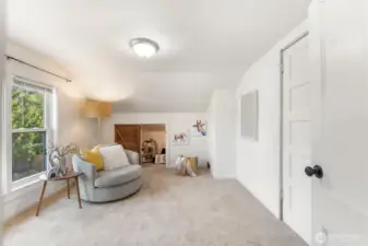 Bright upstairs bedroom #4 with flexible layout, perfect for a seating area, playroom, or study.