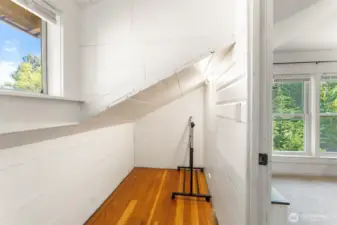 Large upstairs bedroom #4 with closet space and multiple windows bringing in abundant natural light.