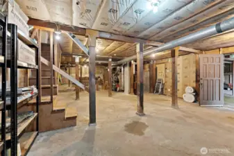 Expansive unfinished basement with high ceilings, abundant storage, shop space, and potential for future ADU or multigenerational living.