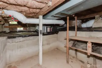 More storage area in partial basement.  Furnace is accessible here and there are some storage shelves