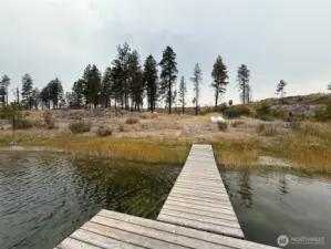 Looking back to shore at the building/camp site. The well is housed inside the protective green container to the right above the dock.