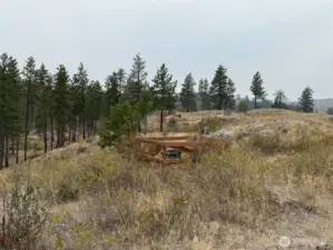 Buried 1000 gallon cistern on the ridge above the building site.