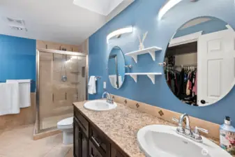 Primary bath with walk in shower and dual vanity . Same custom cabinets here!