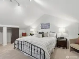 Vaulted ceilings add a grand feel to this beautiful primary bedroom