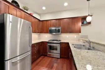 Full kitchen with under cabinet lighting, stainless steel appliances - including a gas range. Also, Cherry stained alder cabinets and granite countertops.