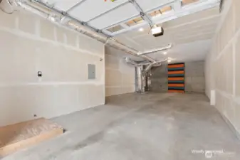 Virtually decluttered 2 car tandem garage with large workshop area and panels to hide shelving at back if you desire to add shelves.