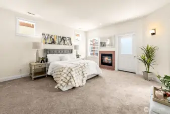 Opulent primary bedroom with the gas burning fireplace and a balcony.