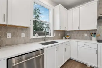 This kitchen has tons of storage and great work space!  Showing another staged home in the community, white cabinetry is an upgrade.