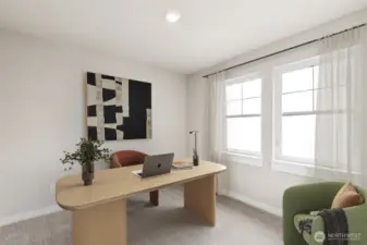 Showing the bedroom upstairs used as an office, virtually staged.