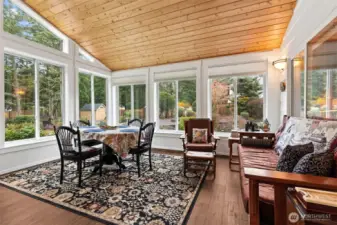 The sun room; from the entrance looking to the right. What a perfect place to watch nature in your back yard & relax while protected from the weather!