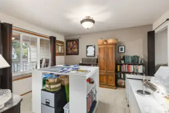 This is the Dining Room, located just off the kitchen & family room. You can see how flexible this space is while it's currently being used as a sewing/quilting room. Many options here with your imagination...maybe an office or TV room. Carpeted flooring.