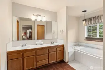 Double sink vanity and jetted soaking tub in the primary ensuite bathroom.