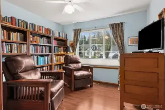Bedroom #3 with view of the front yard. Walnut flooring. Walk-in closet.
