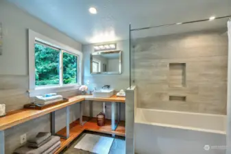 Indulge in the epitome of relaxation and luxury with this shared bathroom featuring a deep spa tub.
