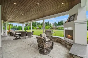 Great entertaining area in the covered outdoor living space with a fireplace.