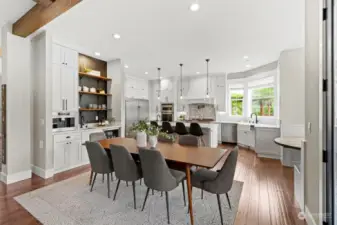 Additional dining area behind the island and more to the right in the built in dining area. Amazing appliances and a built in expresso machine with insta hot water and sink.