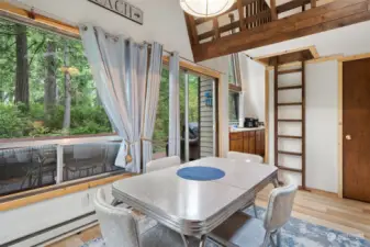 Dining area toward slider, kitchen and ladder to loft