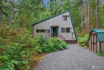 Driveway to front door.  Handy storage shed.  Note, new metal roof for each.